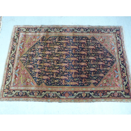 235 - A 19th/20thC Middle Eastern handmade wool carpet with floral decoration in multicoloured wools on a ... 