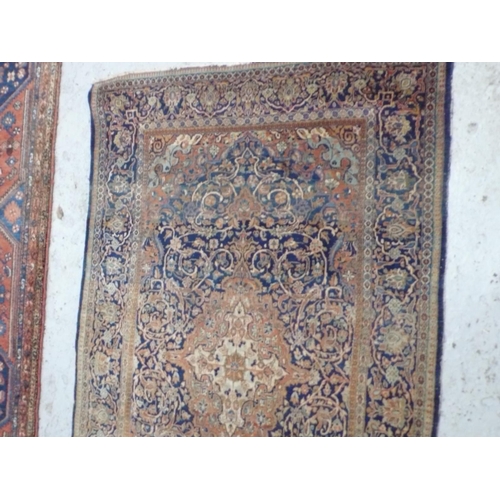 236 - A 19th/20thC Persian hand made fine wool carpet with floral decoration in salmon coloured and blue w... 