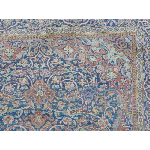 236 - A 19th/20thC Persian hand made fine wool carpet with floral decoration in salmon coloured and blue w... 