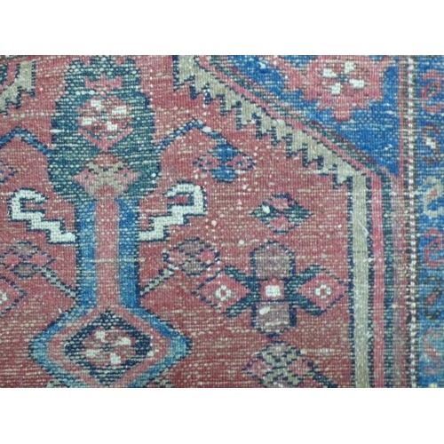 239 - Middle Eastern handmade wool runner with geometric designs in mainly red and blue wool, 113x29ins