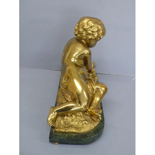 24 - An Ormolu figure of an infant touching a butterfly on a green figured marble base, height 9.75ins