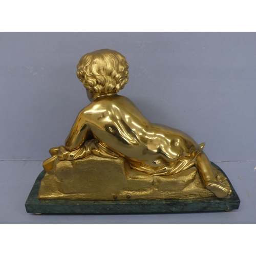 24 - An Ormolu figure of an infant touching a butterfly on a green figured marble base, height 9.75ins