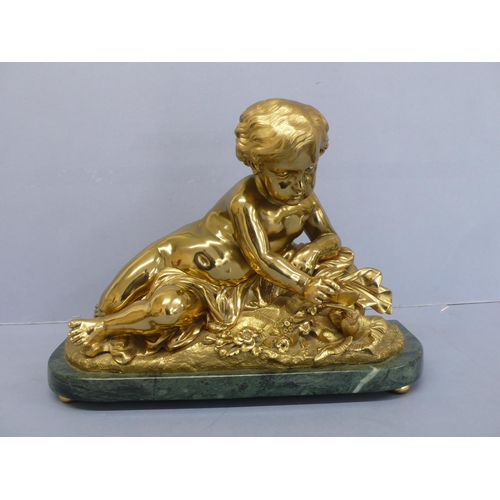 24 - An Ormolu figure of an infant touching a butterfly on a green figured marble base, height 9.75ins