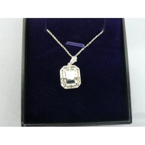 25 - 18ct gold pendant set with a square step cut emerald surrounded by diamonds