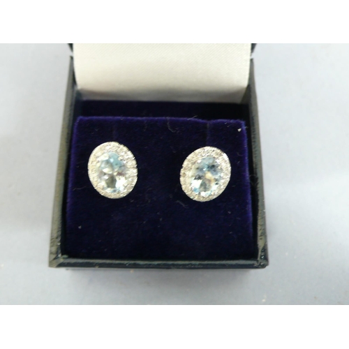 257 - 18ct white gold oval aquamarine and diamond cluster ear studs, aquamarines approx 2.5cts