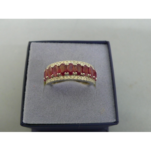 259 - Platinum oval ruby and diamond half hoop ring, size O