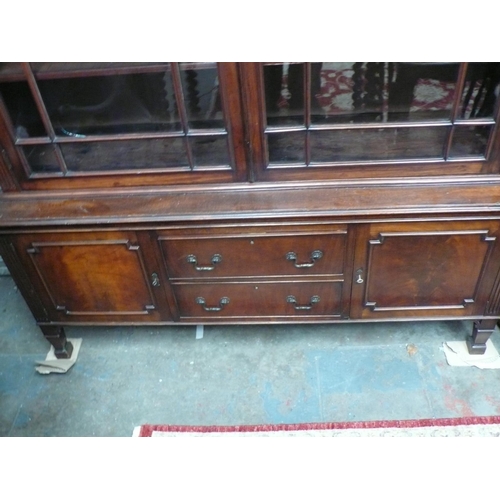 56 - A 19th/20thC mahogany bookcase glazed doors above two drawers, two cupboards, on square legs with  b... 