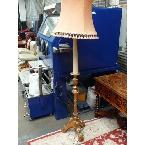 57 - A gilt wood standard lamp with carved tripod base