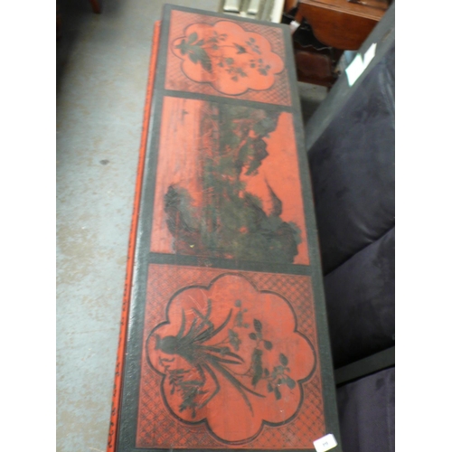 64 - A Chinese red and black painted side table with decoration of lakes, flowers, vases, birds on shaped... 