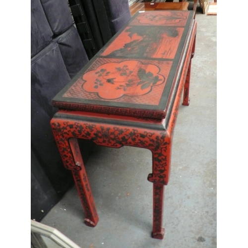 64 - A Chinese red and black painted side table with decoration of lakes, flowers, vases, birds on shaped... 