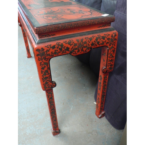 64 - A Chinese red and black painted side table with decoration of lakes, flowers, vases, birds on shaped... 