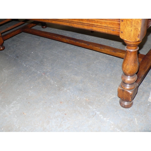 71 - An interesting oak low occasional table with panel decoration to top and central compartment on turn... 