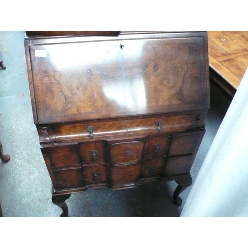 88 - A small walnut veneered bureau book case in the Georgian style with drawers below on cabriole legs -... 