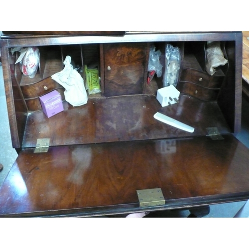 88 - A small walnut veneered bureau book case in the Georgian style with drawers below on cabriole legs -... 