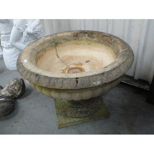 213 - A large carved stone campana urn - diameter 35 ins approx  height 36 ins approx (cracked)