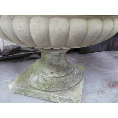 213 - A large carved stone campana urn - diameter 35 ins approx  height 36 ins approx (cracked)