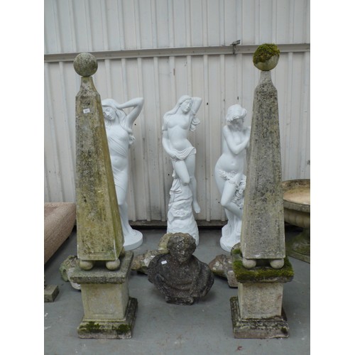 221 - A pair of carved stone obelisks with ball finials, square tapering column, four ball supports on ste... 