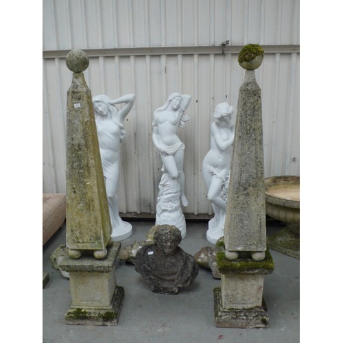 221 - A pair of carved stone obelisks with ball finials, square tapering column, four ball supports on ste... 