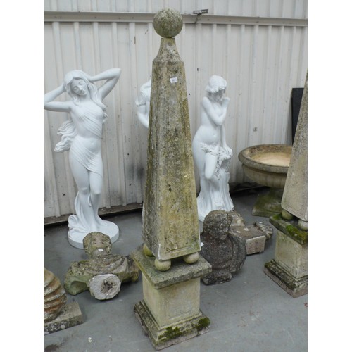 221 - A pair of carved stone obelisks with ball finials, square tapering column, four ball supports on ste... 