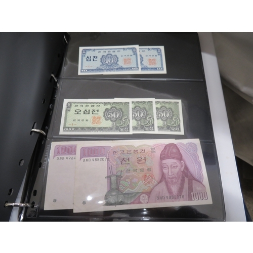 A folder of worldwide bank notes
