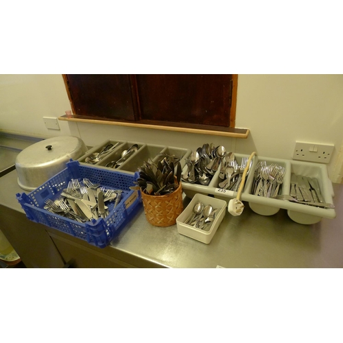 235 - A large quantity of stainless steel cutlery including cutlery containers (located in kitchen area)