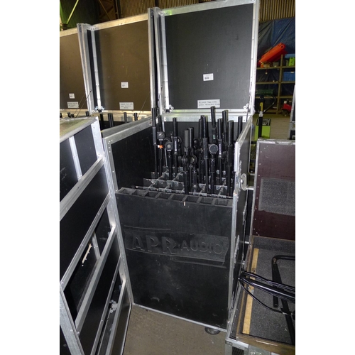 600 - 1 wheeled flight case with hinged front and top containing a quantity of various microphone stands