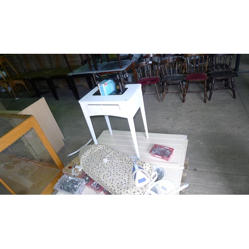 35 - A quantity of various items including a Singer sewing machine, slat wall, slat wall fittings, an iro... 