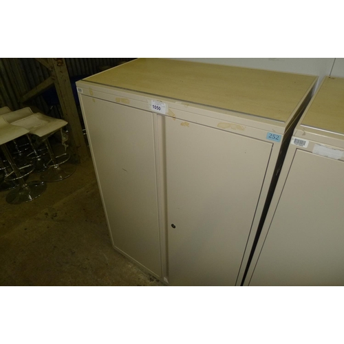 1050 - 1 light brown metal 2 door storage cabinet with sloping top