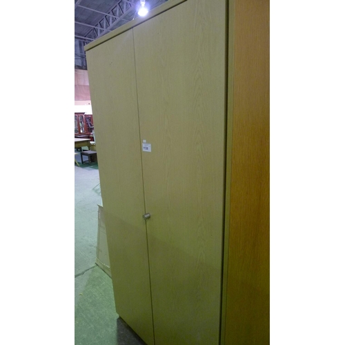 1138 - 1 tall light wood effect two door storage cabinet