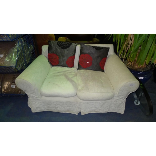 1278 - A two person sofa with light coloured covers and 2 rose cushions