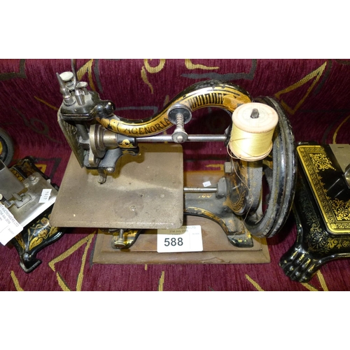 588 - A small decorative antique hand cranked sewing machine 