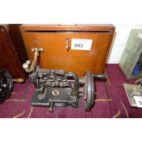 593 - A small antique hand crank sewing machine with a wooden carrying box