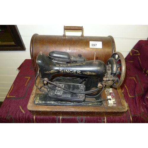 597 - A vintage singer electric sewing machine with a wooden carrying case