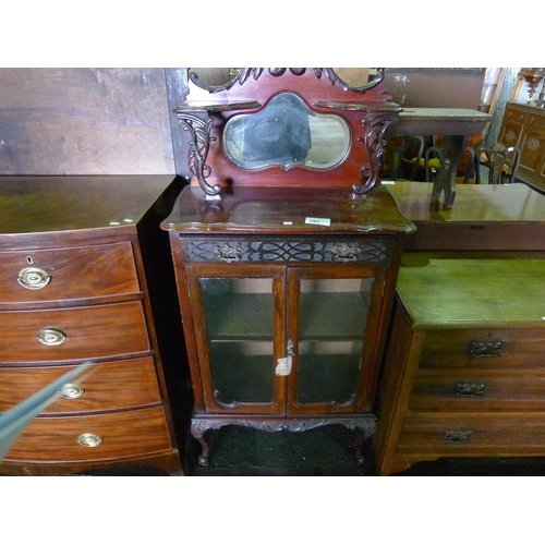 791 - An Edwardian mahogany cabinet with a mirrored back, a small drawer and two glass doors below