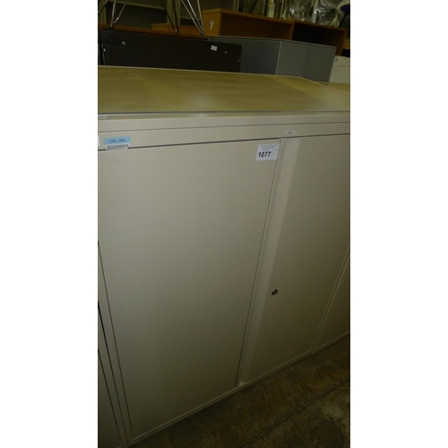 1077 - One light brown metal two door storage cabinet with sloping wood effect top -  medium-sized