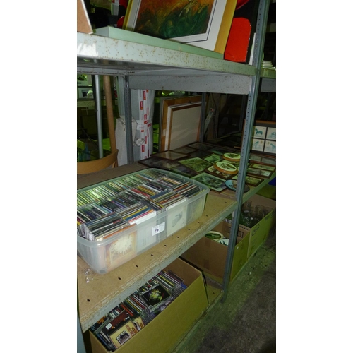 79 - A large quantity of various music CDs and several framed prints. Contents of one bay / 3 shelves