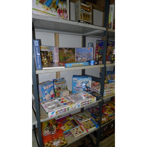 311 - A quantity of various children's toys puzzles etc, contents of four shelves