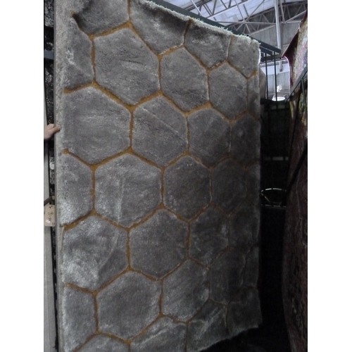 1468 - 2 large floor rugs comprising 1 x black / white / grey patterned RRP £93 & 1 x grey / orange hexagon... 