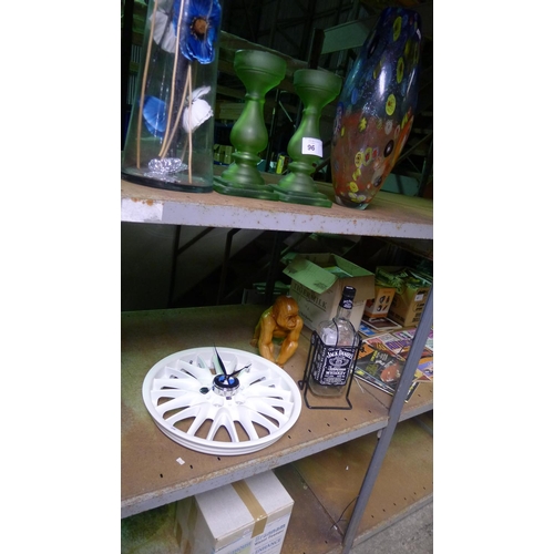 96 - A quantity of various items including a clock made from a BMW wheel, a wooden gorilla, vases, a wate... 