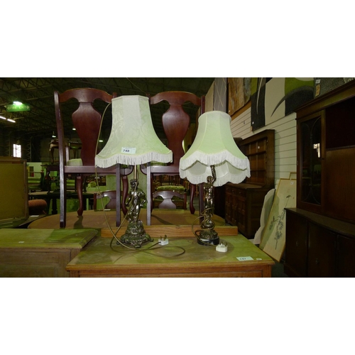 748 - Two similar gilt decorated cherub table lamps with white shades