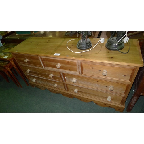 749 - A modern pine bedroom chest of 3 short and 4 long drawers with turned knobs