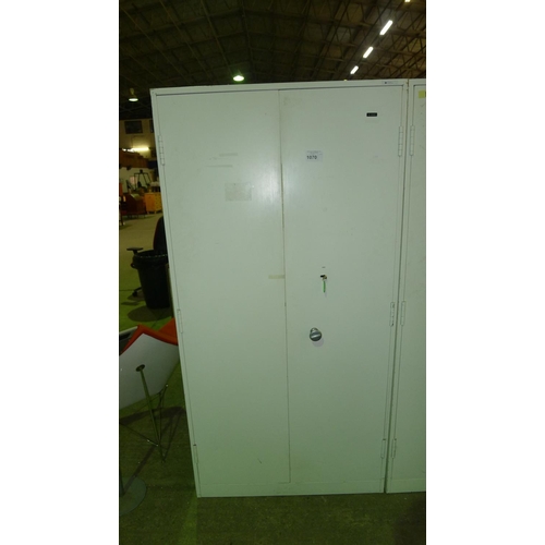 1070 - 1 white metal heavy duty 2 door storage cabinet approx 6ft by 3ft supplied with 1 key