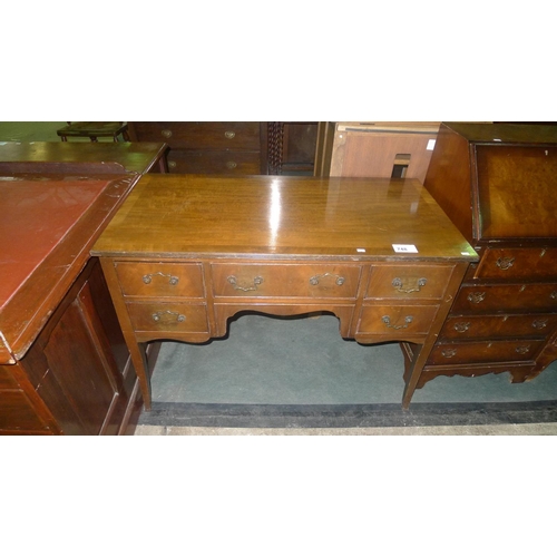 748 - A mahogany rectangular top kneehole writing table with 5 small drawers