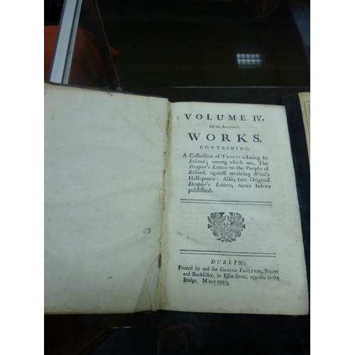 596 - A leather bound volume of Swifts works dated 1735 and a volume of Du Moulin's reflections dated 1681