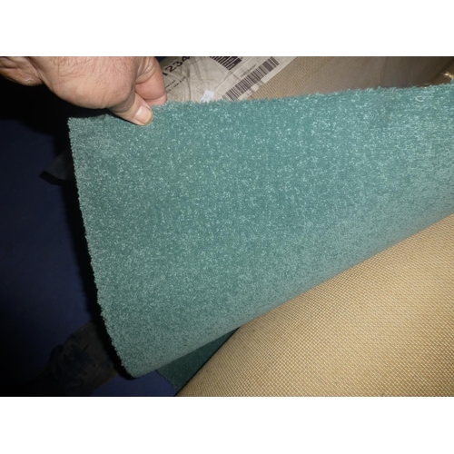 1215 - 1 part roll of green carpet - label on carpet giving size appears to be incorrect