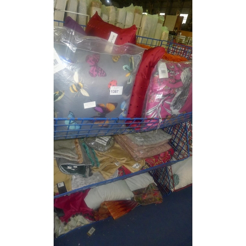 1387 - A quantity of various cushions. Contents of 3 mesh stacking baskets which are not included