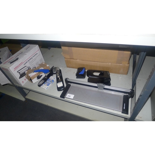 235 - A quantity of various office related items including stapler, a trimmer etc. Contents of one shelf