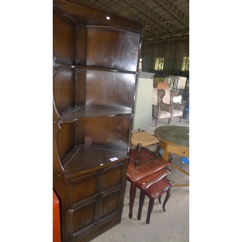 27 - 1 Ercol dark wood corner cabinet, a nest of 3 tables and 1 foot stool