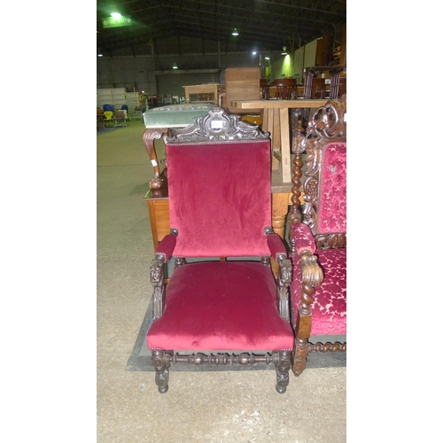 779 - A heavily carved oak elbow chair with griffin motif and lion elbows