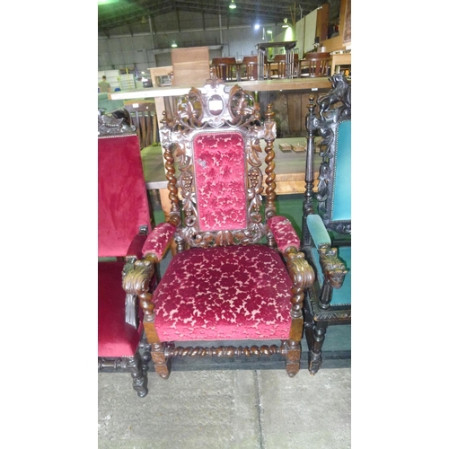 780 - A heavily carved oak elbow chair with scroll arms and wine coloured upholstery